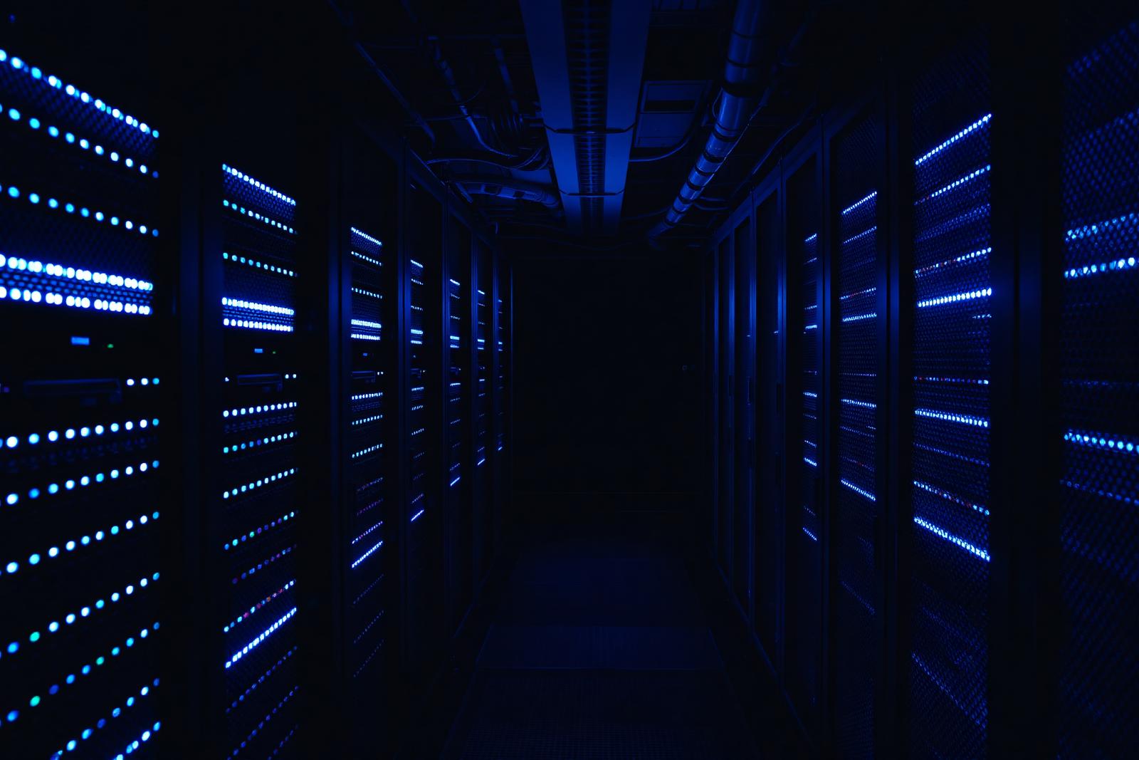 Data centre corridor with server racks and blue status lights